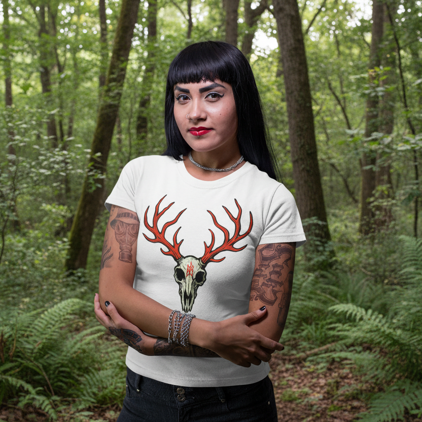 Woman wearing a white t-shirt with a deer skull design on a purple background